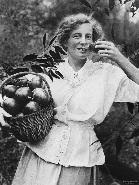 woman with a basket of mandarins